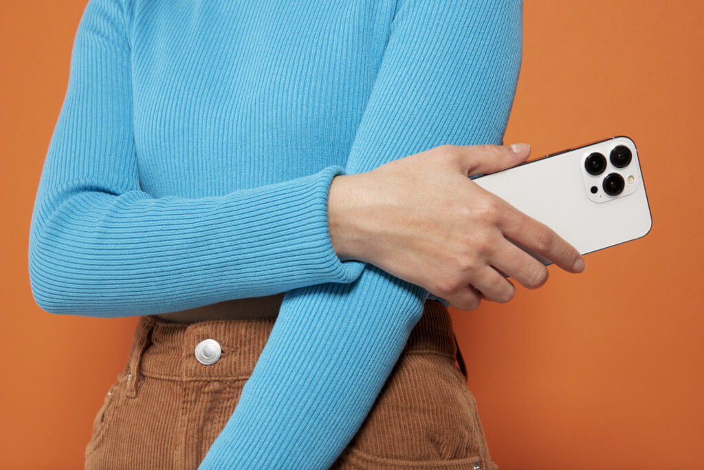 front-view-woman-showing-her-smartphone