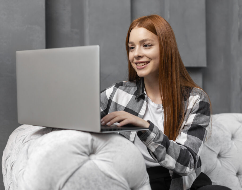 happy-female-typing-laptop