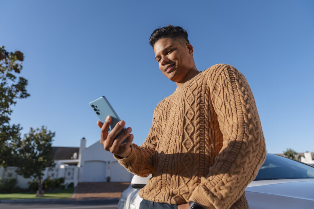 low-angle-man-using-smartphone-outdoors