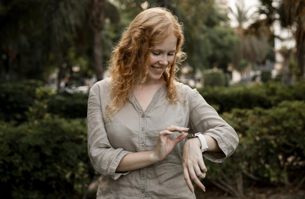 mid-shot-woman-looking-smartwatch